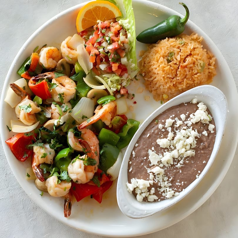 Luna Mexican Cuisine's shrimp fajitas with bell peppers, onions, rice, refried beans, and pico de gallo.